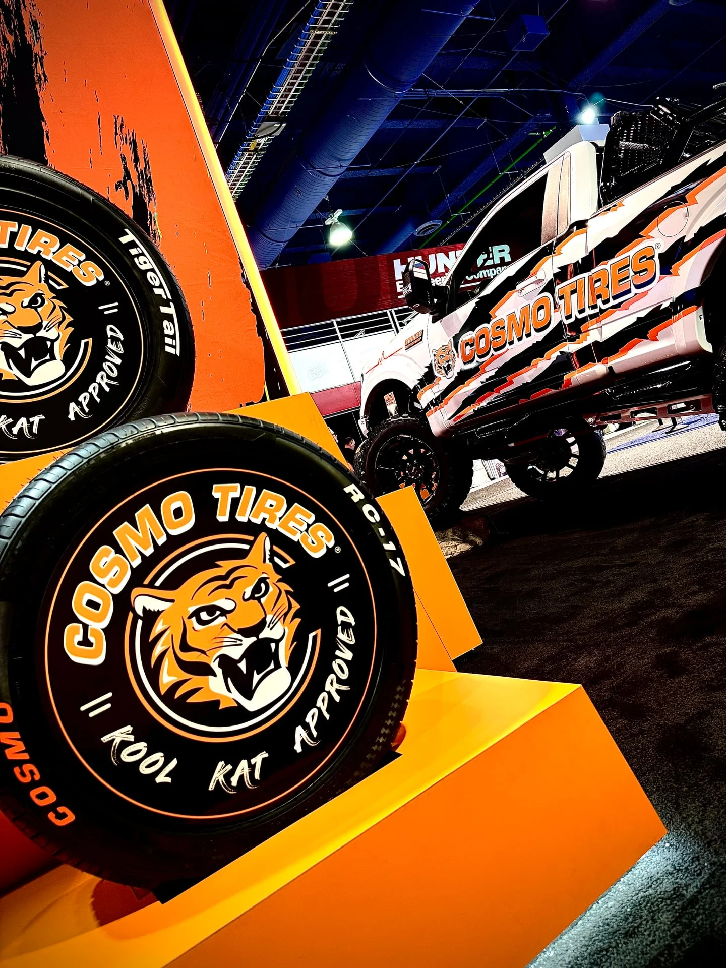 A lifted Ford F-150 built by Ernie's Custom Shop, on the SEMA show floor in the Cosmo Tires booth